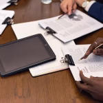A business meeting with tablets and documents showcasing digital integration