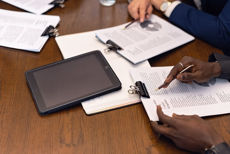 A business meeting with tablets and documents showcasing digital integration